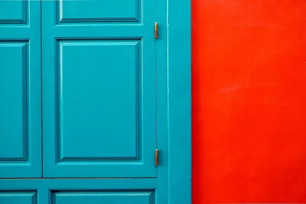 A deep blue front door set into a red brick facade