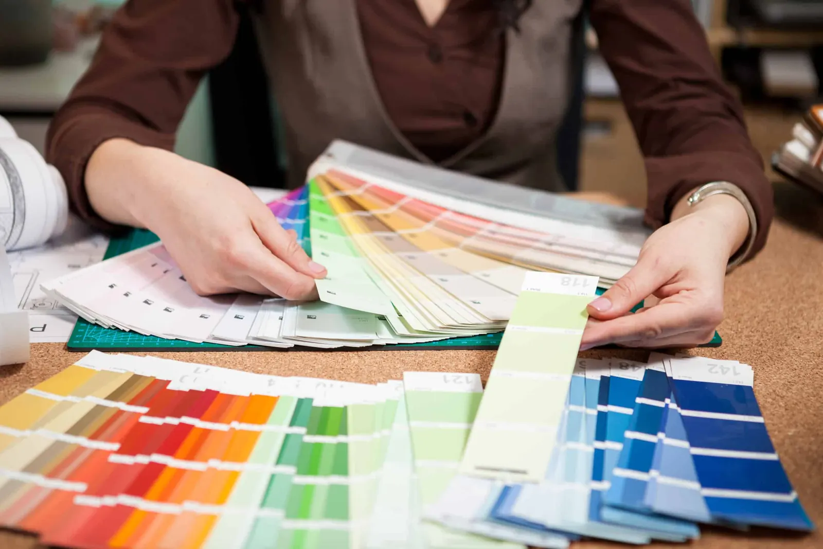 A designer working through a color palette at a desk