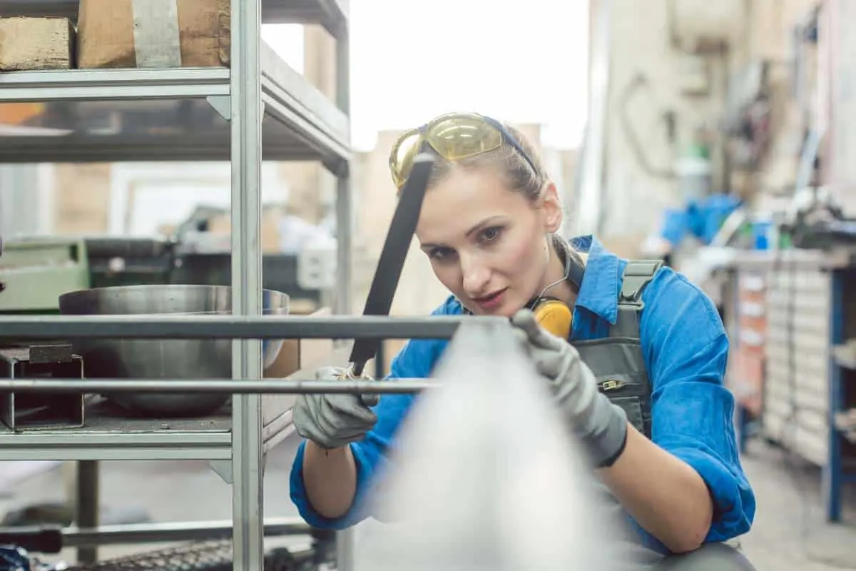 Primer being applied to a prepared metal surface