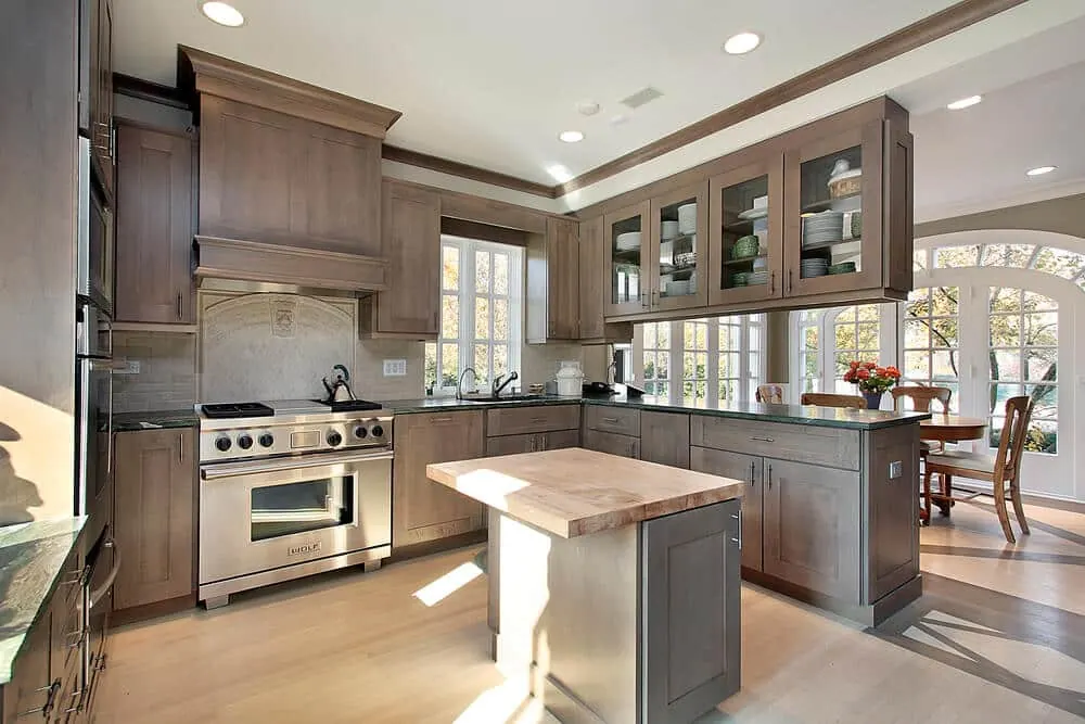 A large kitchen with deep navy cabinets and neutral countertops