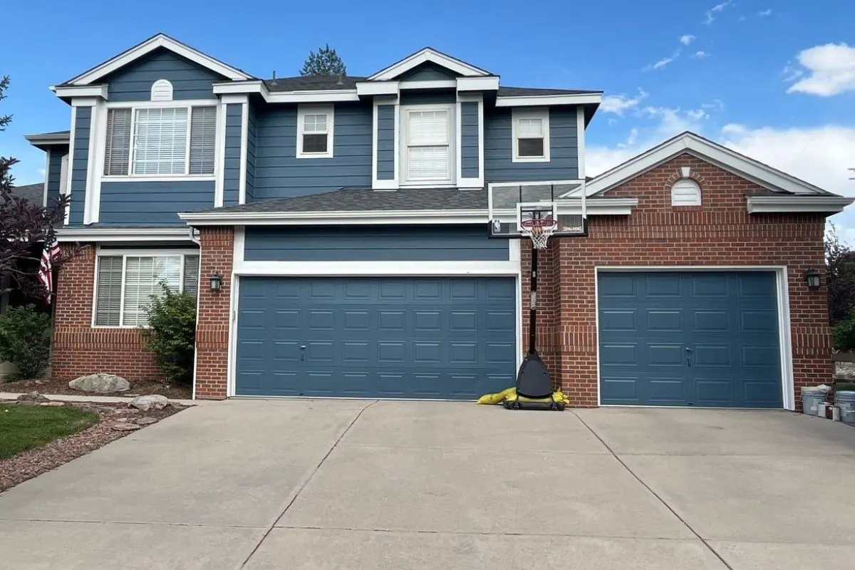 A home exterior painted in neutral tones and staged for sale