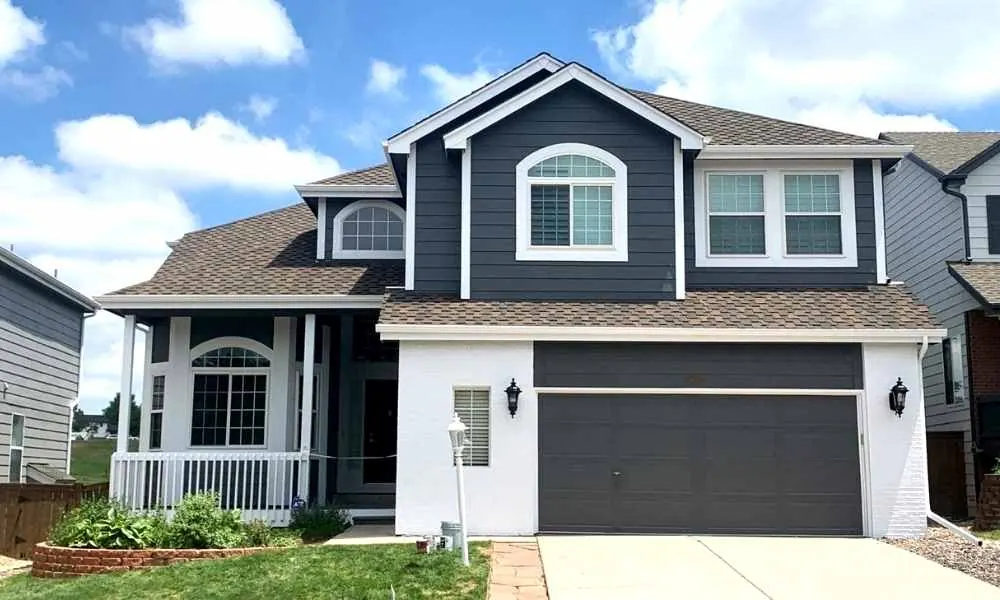 A white and blue Denver home exterior painted by Kind Home Painting