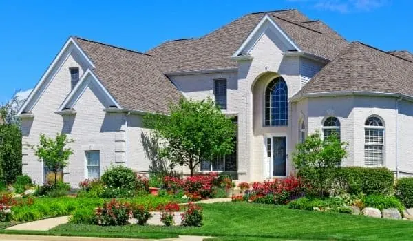 A two story brick home painted white