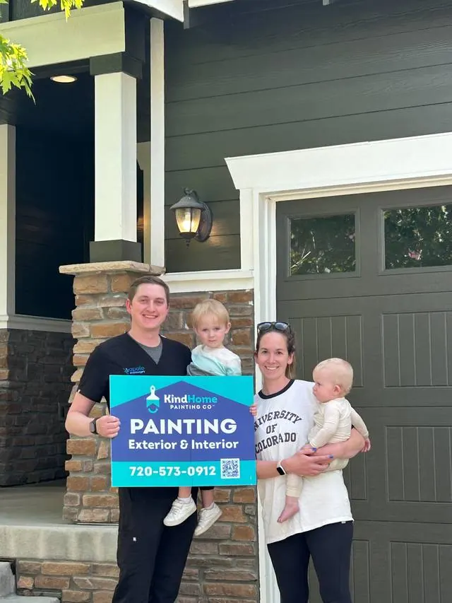 The Moore family in front of their newly painted home
