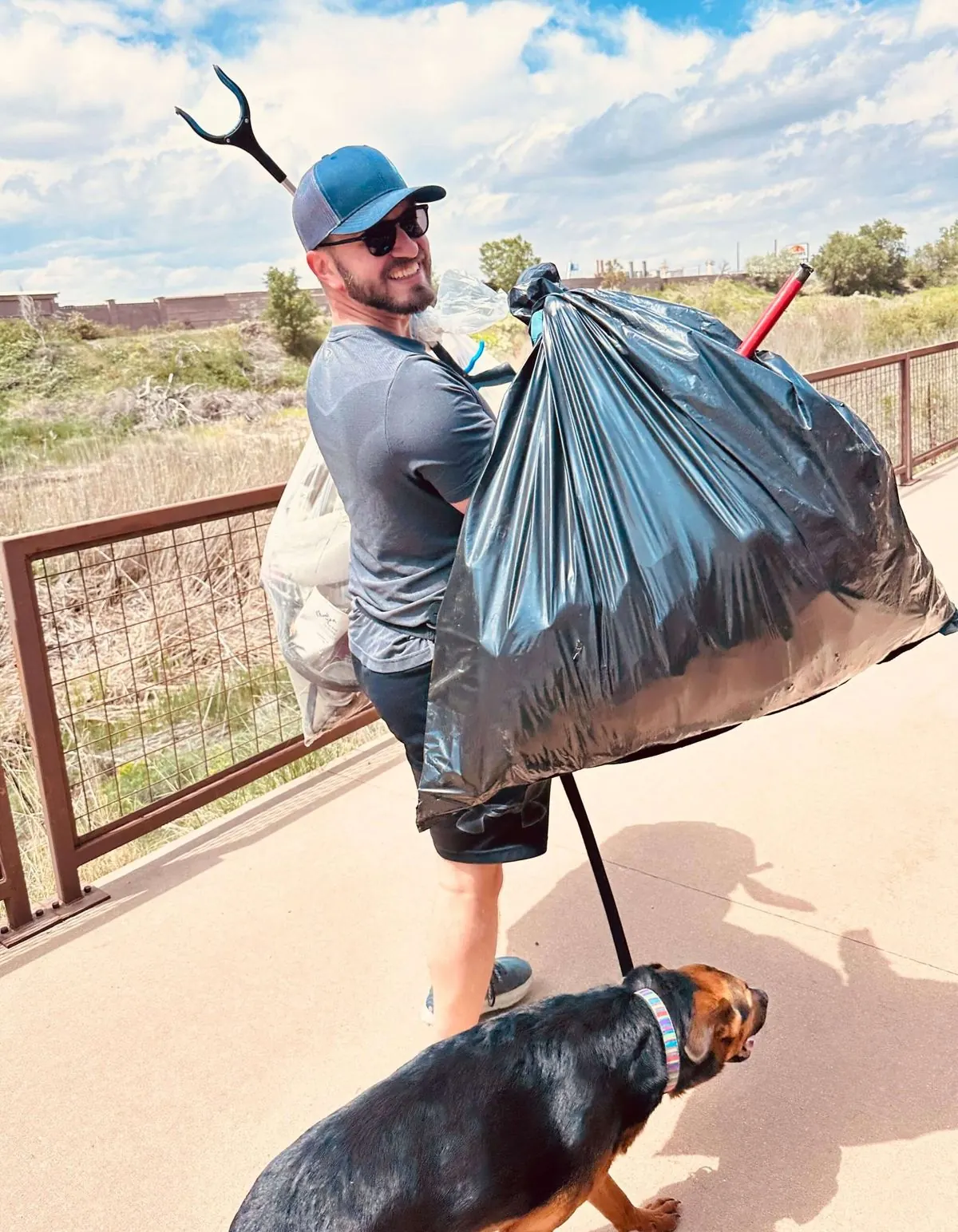 A Kind Home volunteer hauling cleanup bags at a community service event