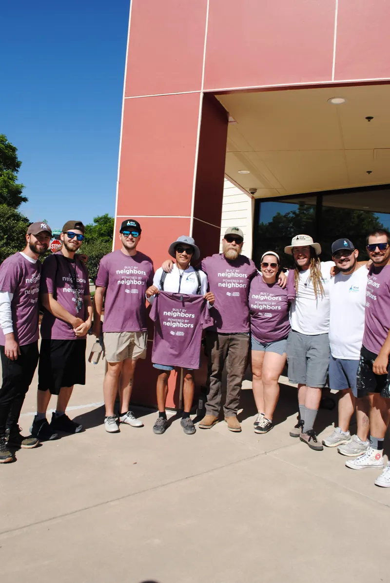 Kind Home Painting volunteers in matching shirts at an Extreme Community Makeover volunteer day in Denver